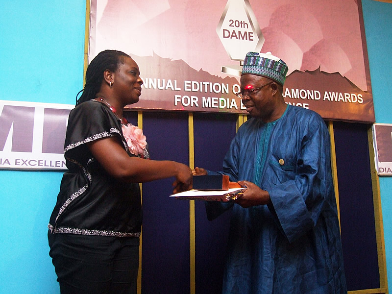 <span  class="uc_style_uc_tiles_grid_image_elementor_uc_items_attribute_title" style="color:#ffffff;">Cordelia Okpei receiving her Radio Reporter of the Year prize from Dr. Sadiq of FRCN</span>